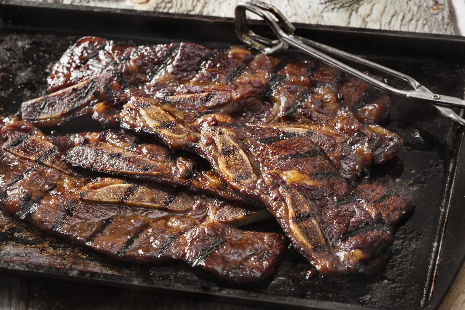 Grilled beef short ribs on metal tray