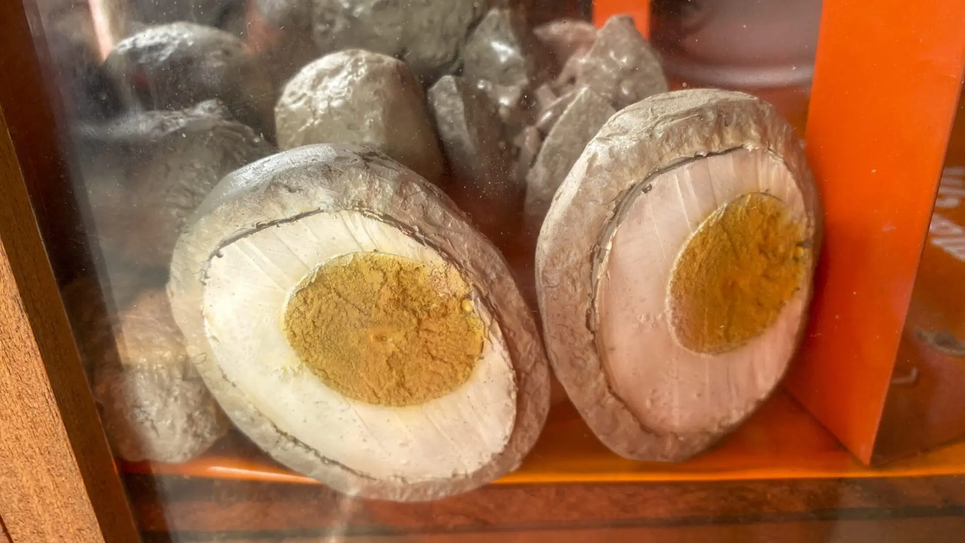 Halved century eggs on display shelf