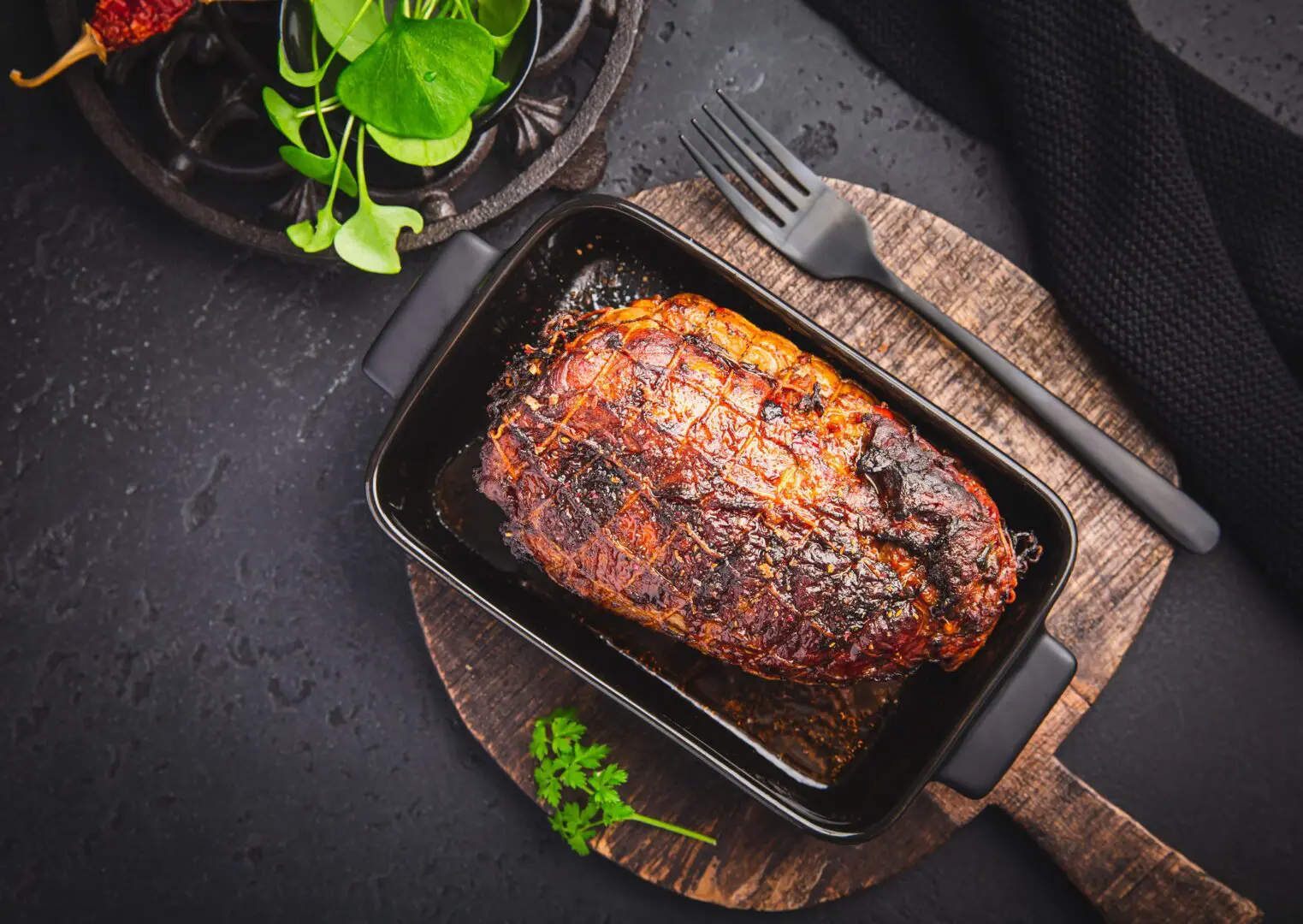 Herb-crusted roasted beef loin in baking dish