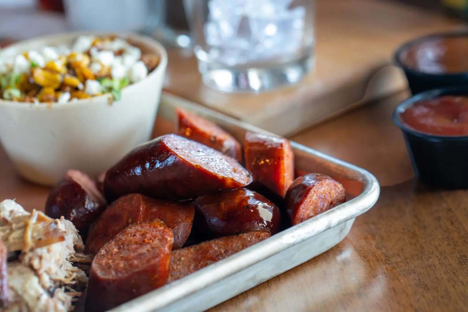 Smoked sausage slices on metal tray