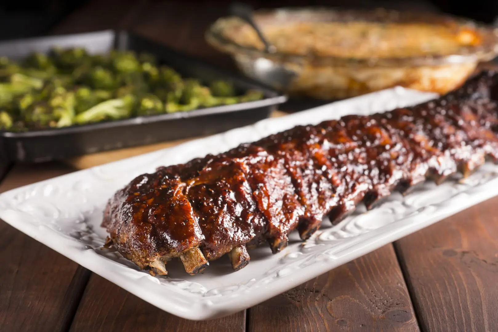 Glazed barbecue pork ribs on white platter