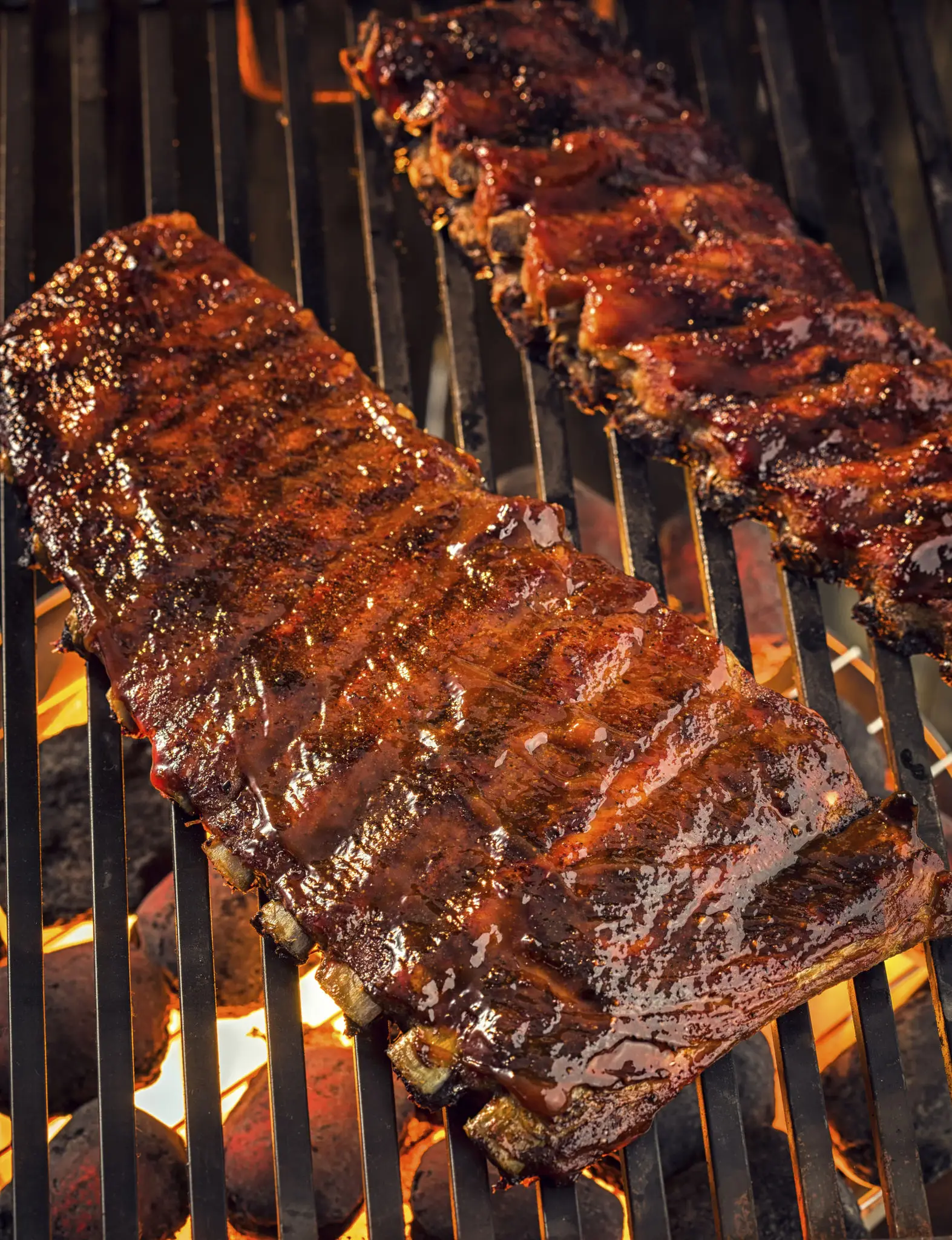 Barbecue ribs sizzling on grill