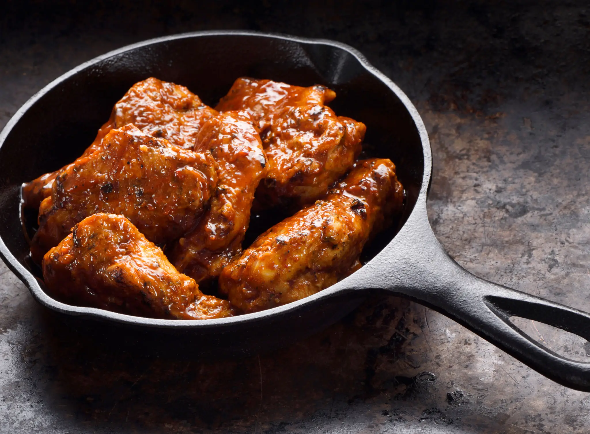 Glazed ribs in a dark skillet