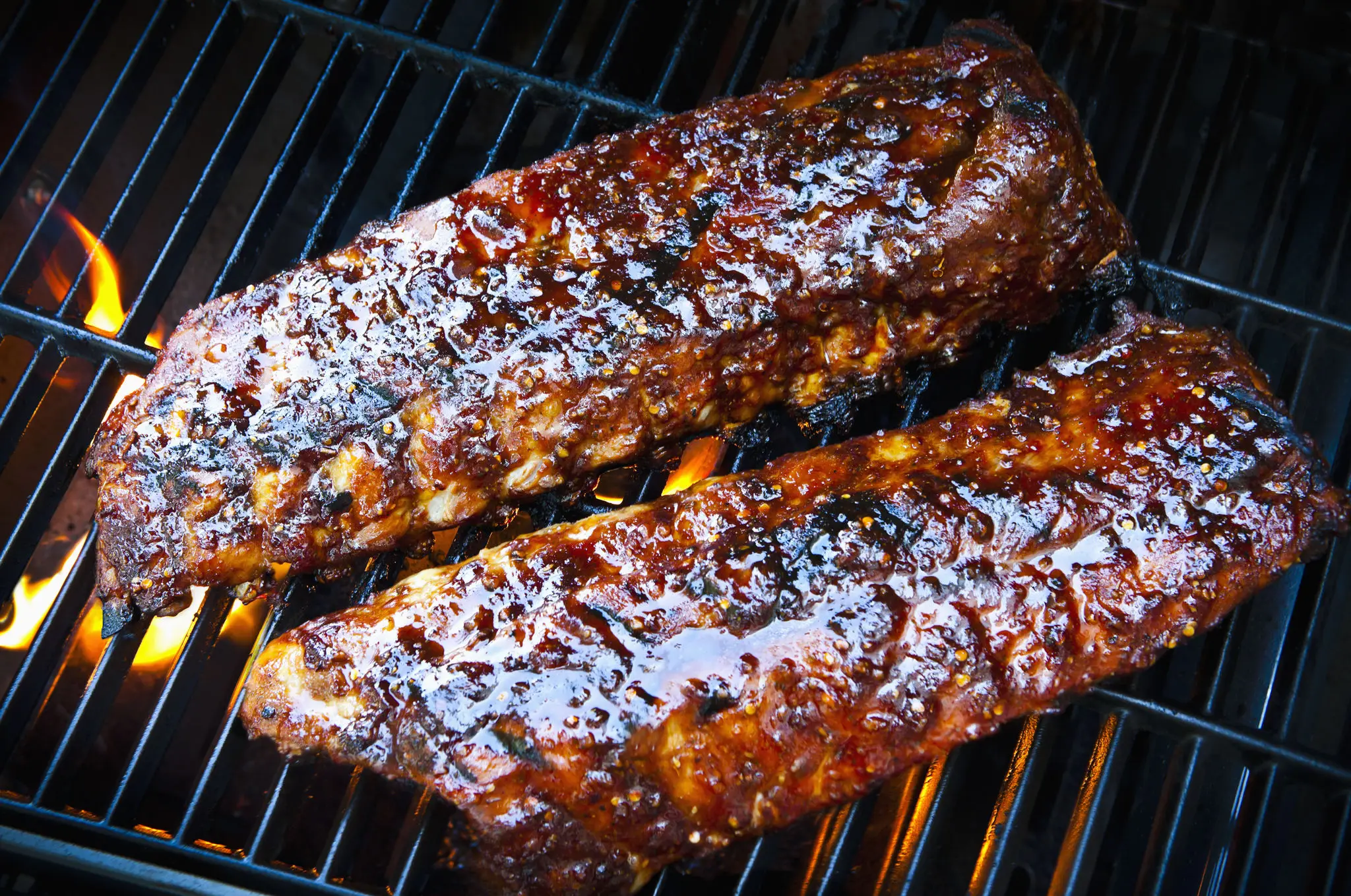 Barbecue ribs grilling on open flame