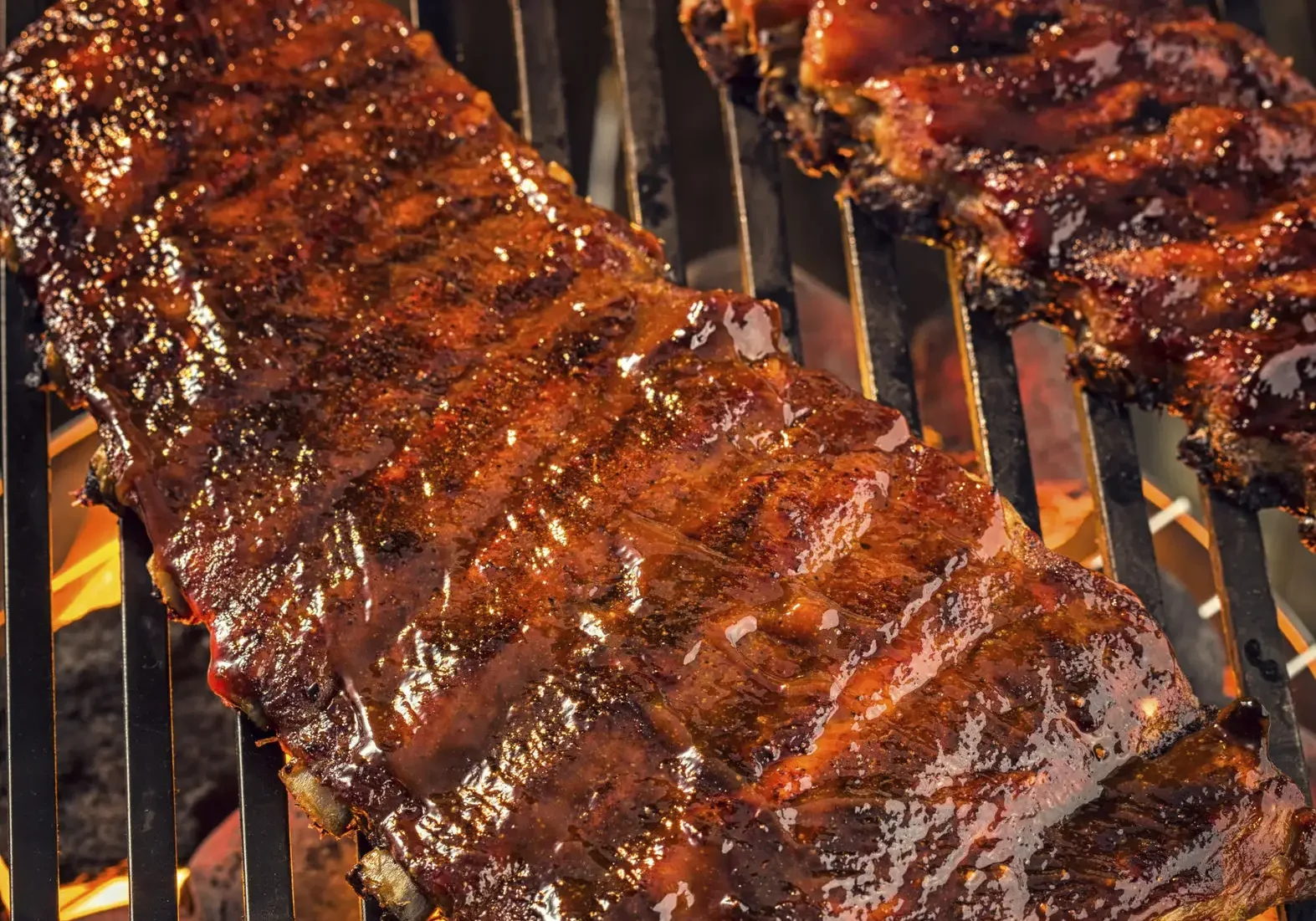 Barbecue ribs sizzling on grill