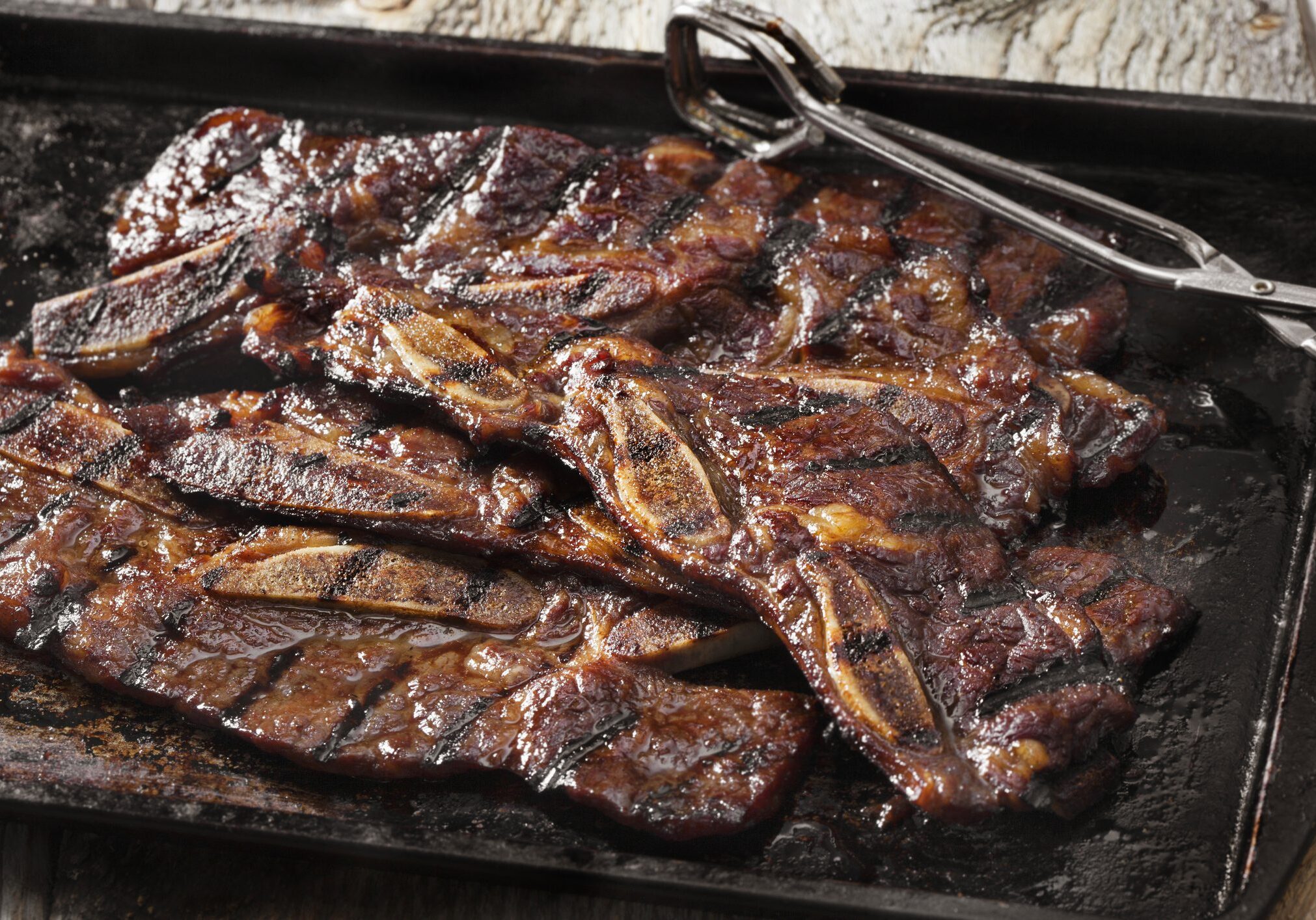 Grilled beef short ribs on metal tray