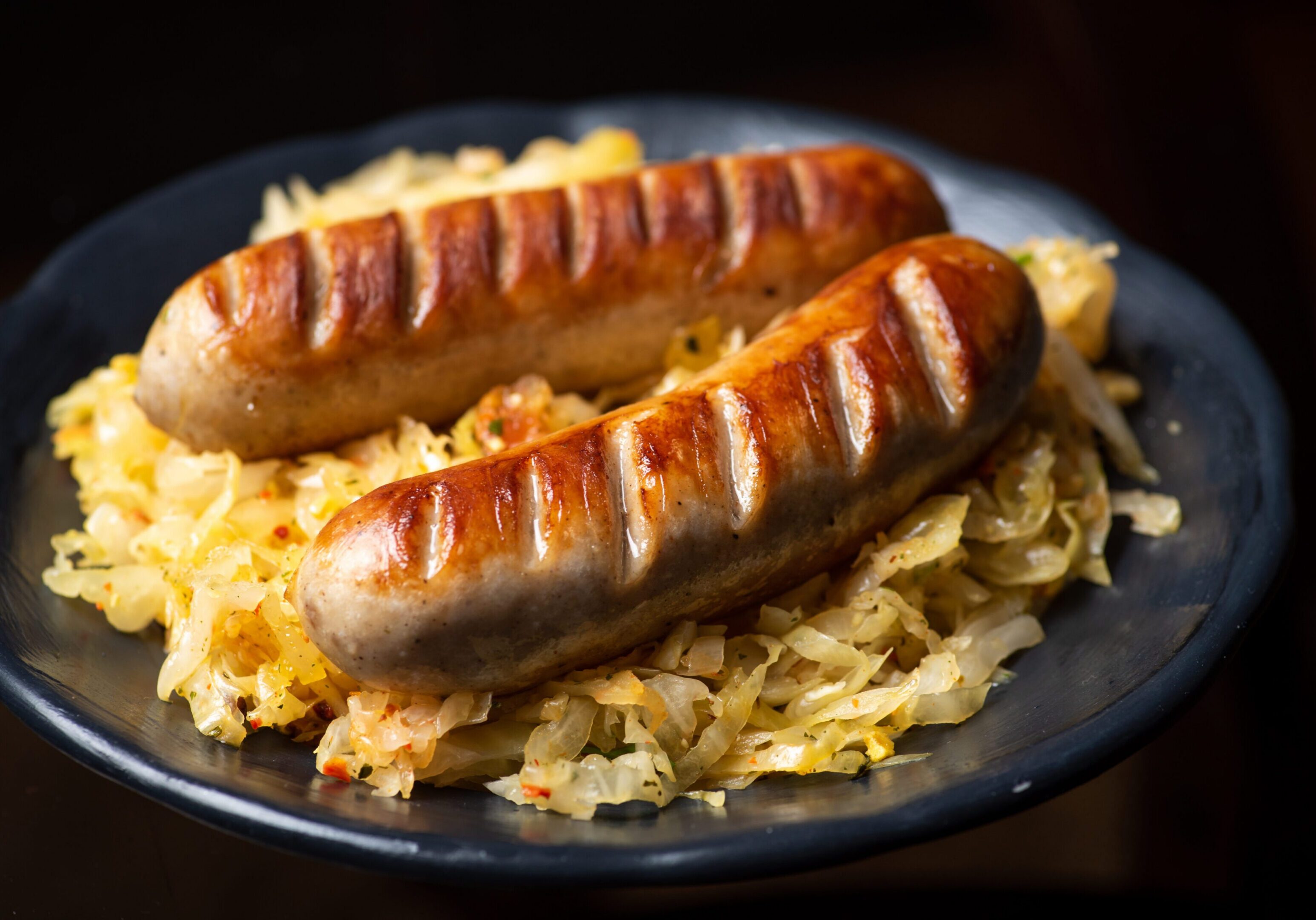 Two grilled sausages on sauerkraut