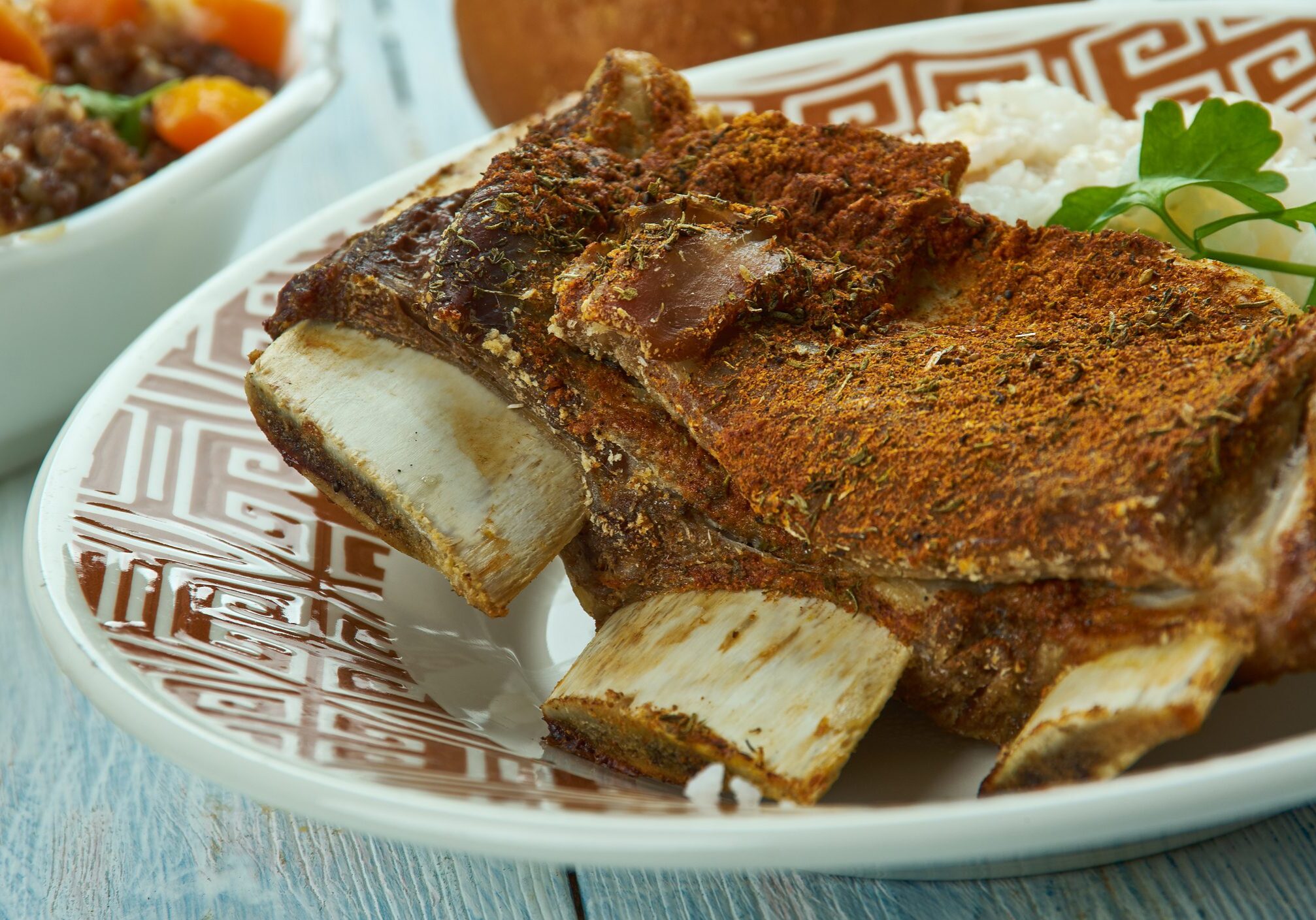Seasoned beef short ribs on patterned plate