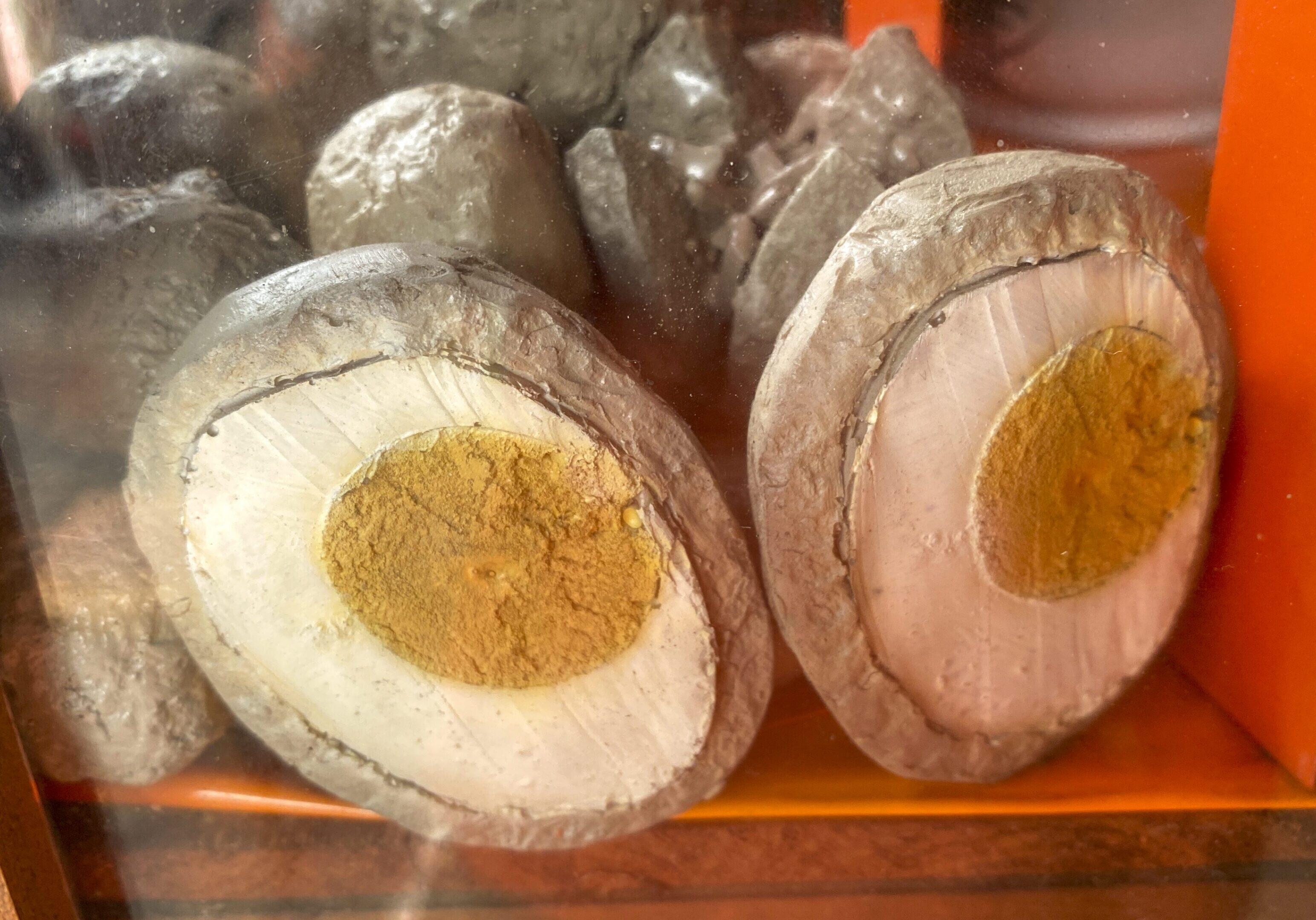 Halved century eggs on display shelf