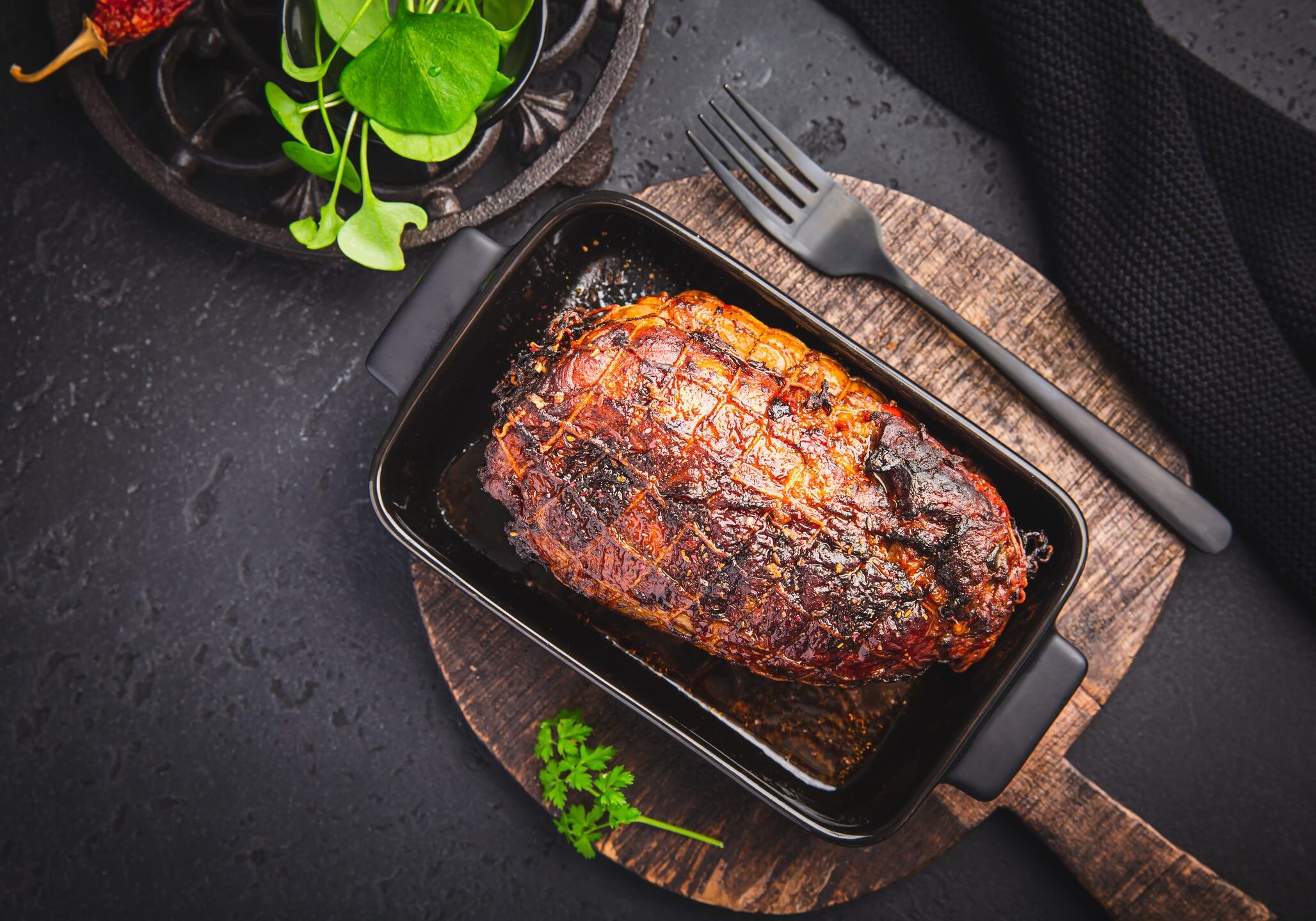 Herb-crusted roasted beef loin in baking dish