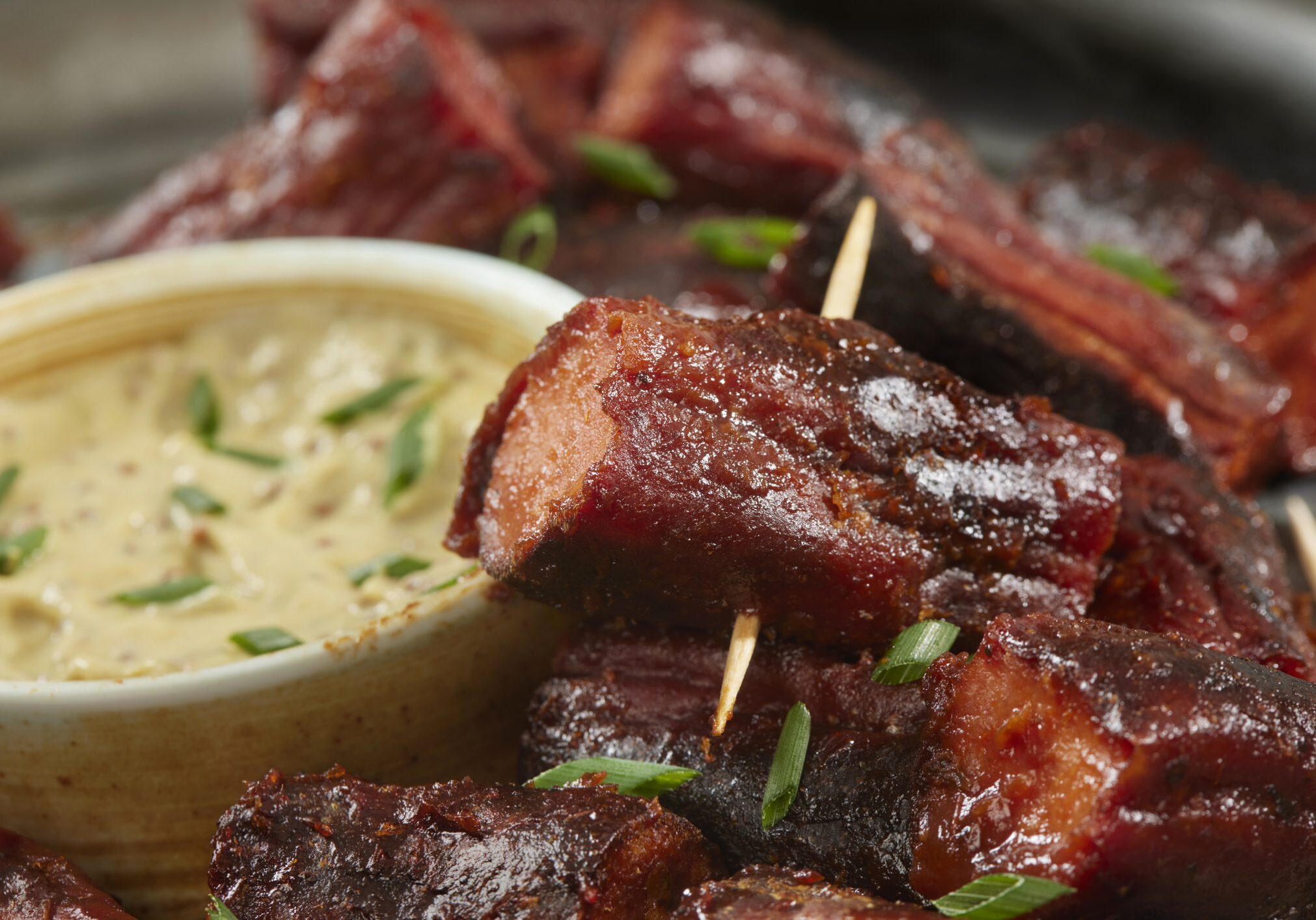 Skewered barbecue pork bites with dipping sauce
