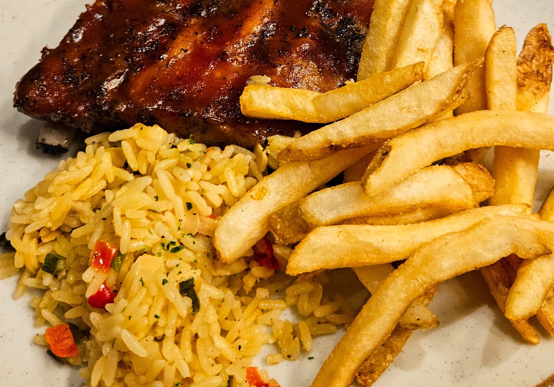 BBQ ribs with fries and seasoned rice
