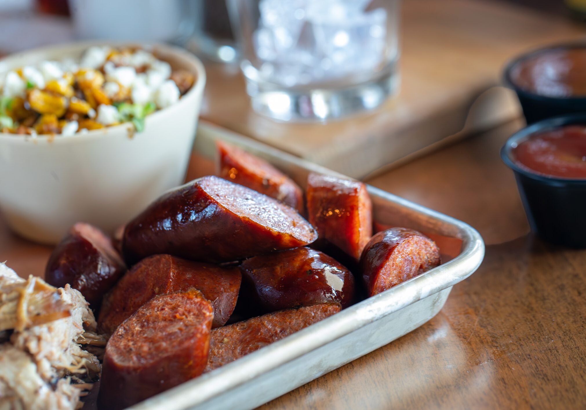 Smoked sausage slices on metal tray