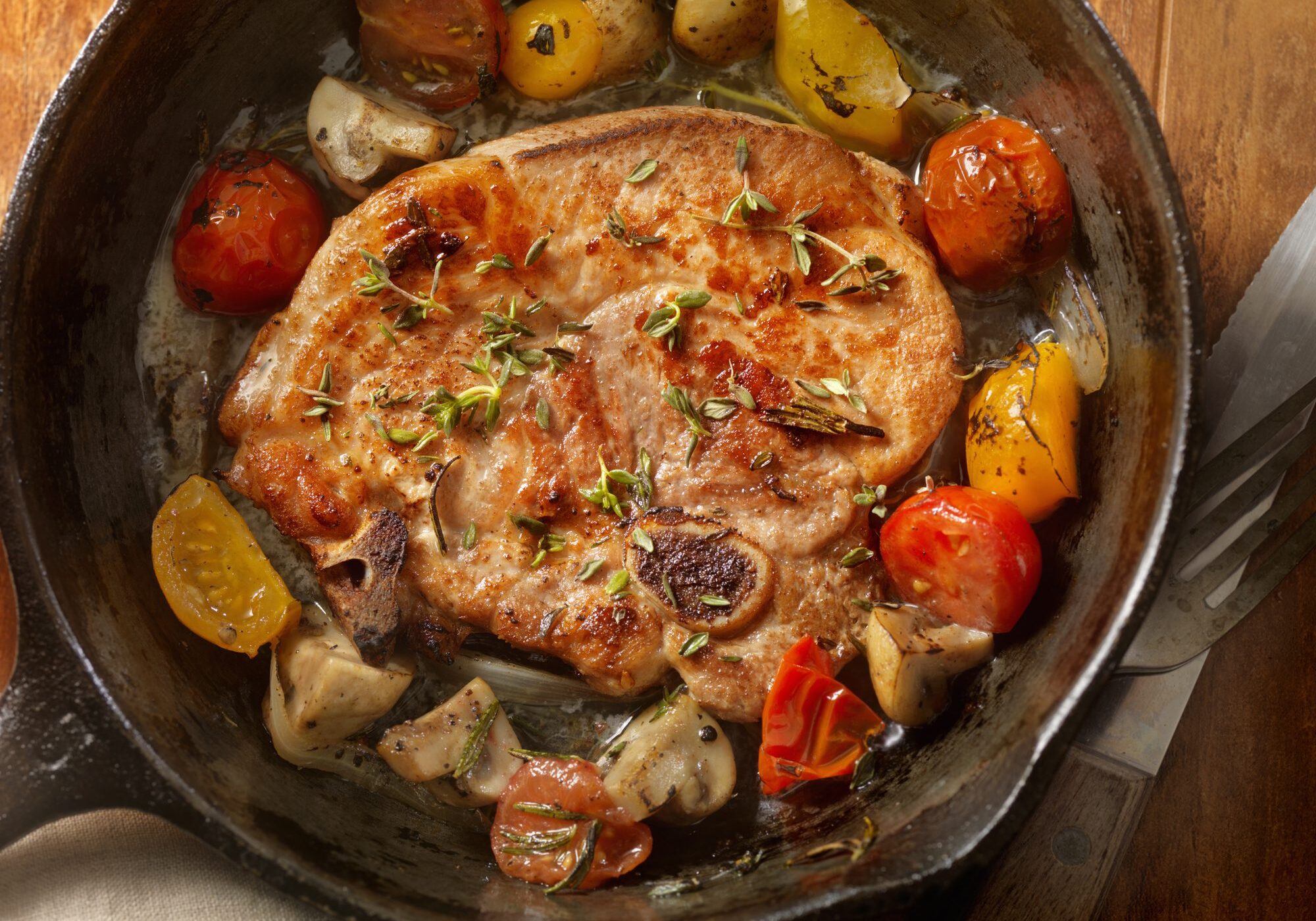 Skillet pork chop with roasted cherry tomatoes