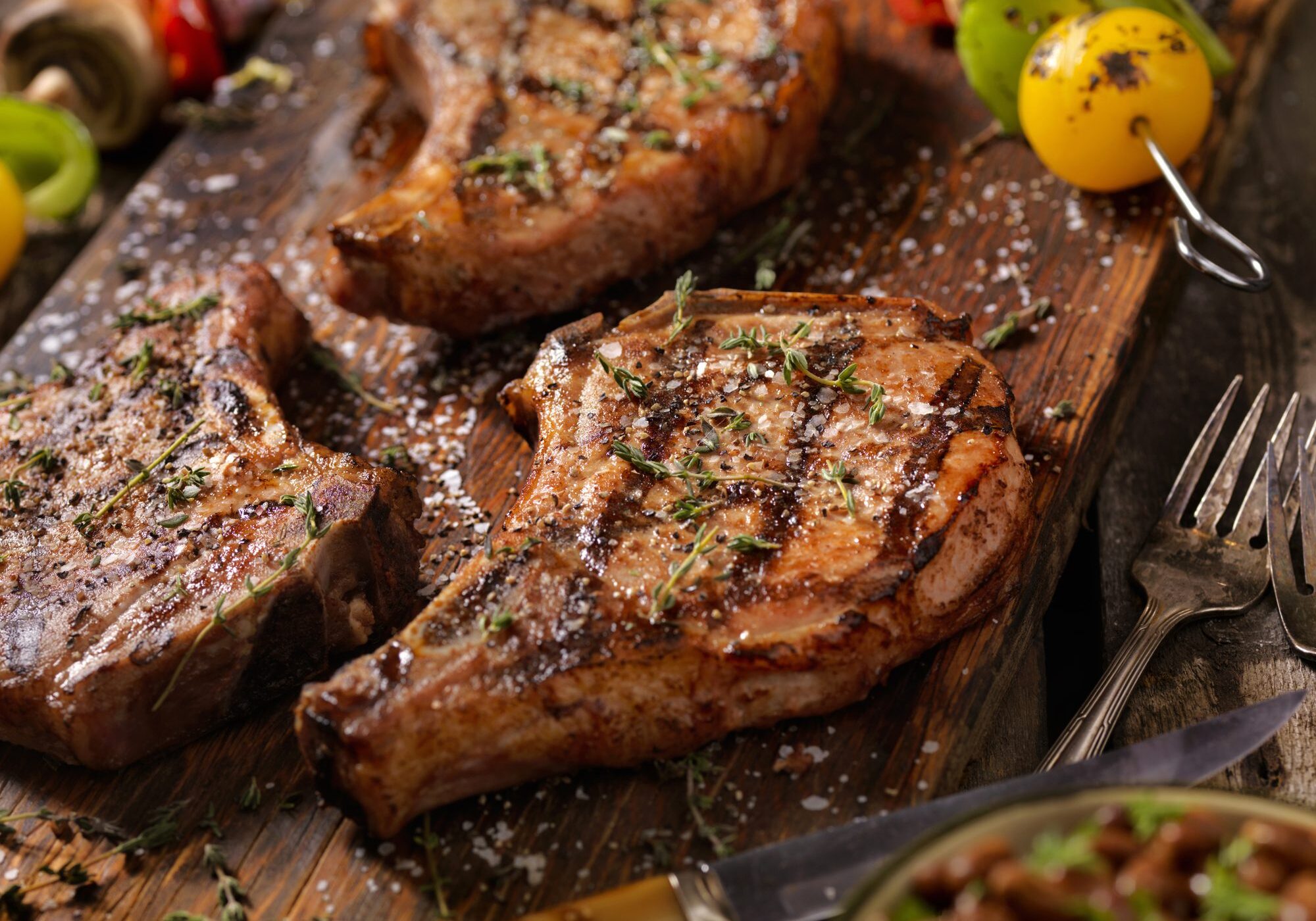 Grilled pork chops with herbs and skewers