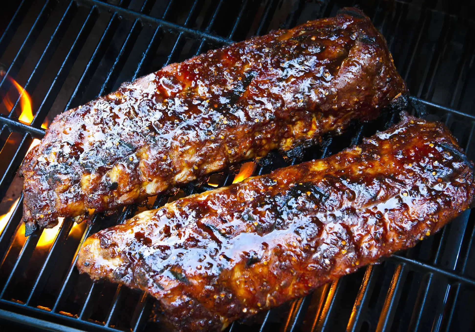 Barbecue ribs grilling on open flame